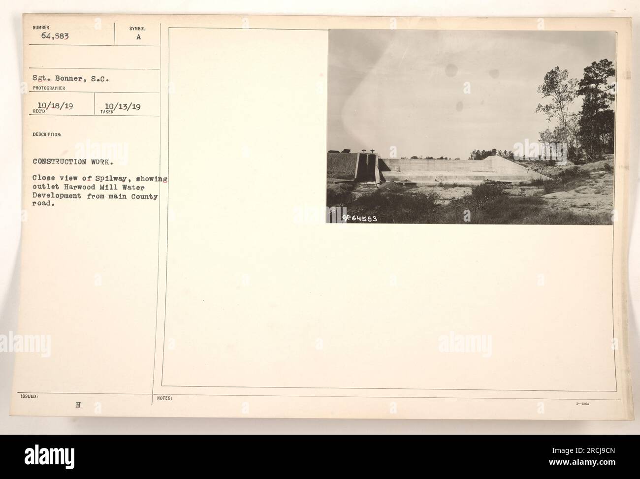 Construction work taking place at Harwood Mill Water Development, as captured by Sgt. Bonner on 10/18/19. The photograph shows a close view of a spillway, with the outlet visible from the main County road. The notes mention the assigned number for the image as 64583 and indicate that it was part of a collection related to construction work. Stock Photo