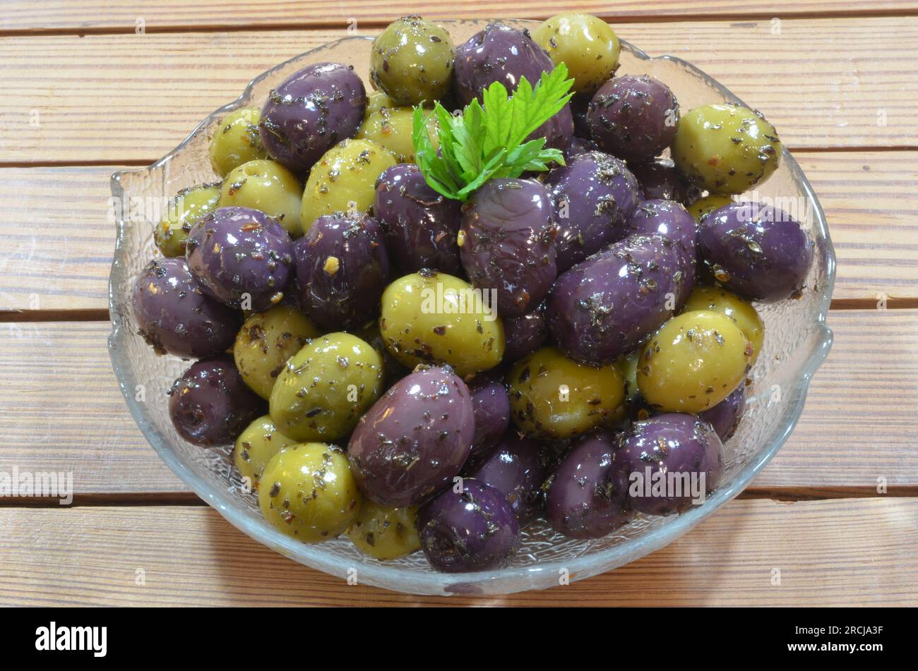 Olives, when of good quality, practically do not need seasoning, but if we give them a little help... Stock Photo