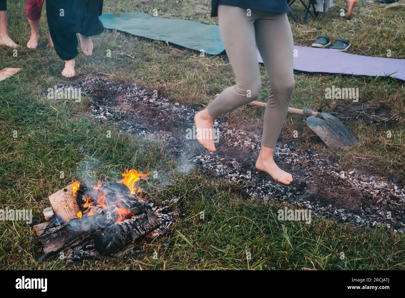 Coal walking or fire walking. Barefoot person on burned wood and hot ...