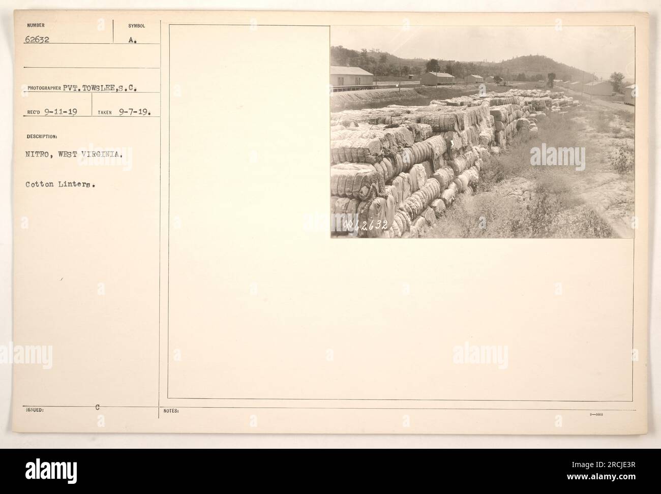 Soldiers unloading equipment at the Nitro, West Virginia military base during World War One. The photograph, taken by Pvt. Towslee on September 7, 1919, showcases a pile of cotton linters, a material used in the production of nitrocellulose explosives. The image was received on September 11, 1919. Stock Photo