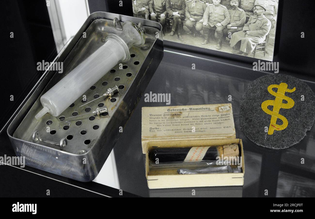 First World War (1914-1918). Germany. From left to right: medic sterilizer with a syringer, pharmaceutical kit for venereal disease treatment and medical service sleeve insignia of the German Army. Latvian War Museum. RIga. Latvia. Stock Photo