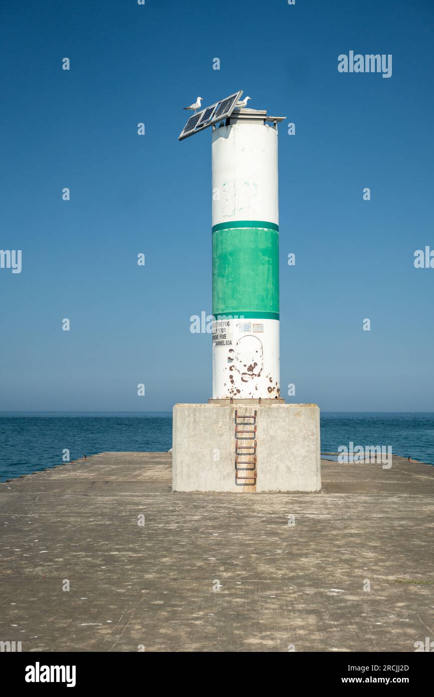 Lighthouse at the end of a pier in Northern Michigan Stock Photo