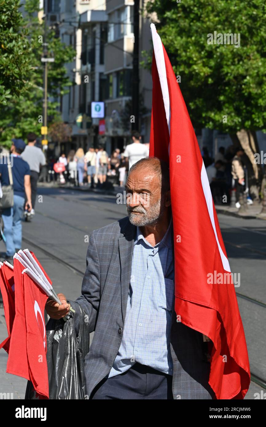 Old turkish man selling turkish flags on the street in Sultanahmet area in Istanbul, Turkey