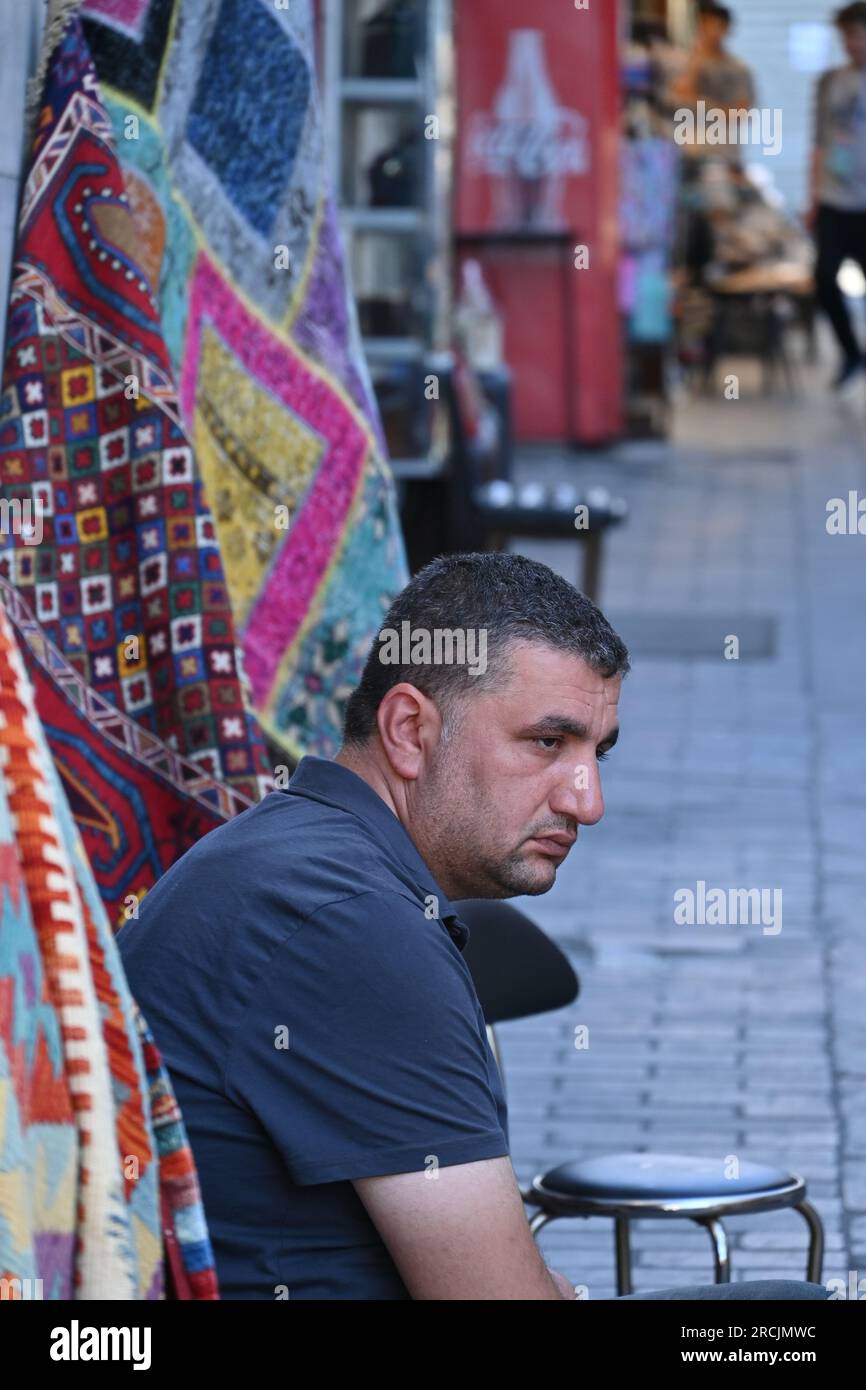 Carpet vendor outside his shop on Sultanahmet area in Istanbul, Turkey Stock Photo