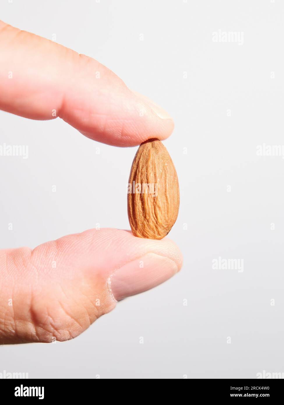 Closeup of ecological almonds on a wood background Stock Photo