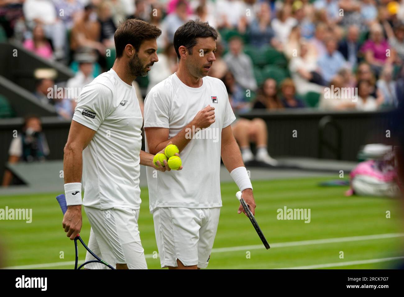 Spain's Marcel Granollers, left, and Argentina's Horacio Zeballos in action  against Britain's Neal Skupski and Wesley Koolhof of the Netherlands during  the men's doubles final on day thirteen of the Wimbledon tennis