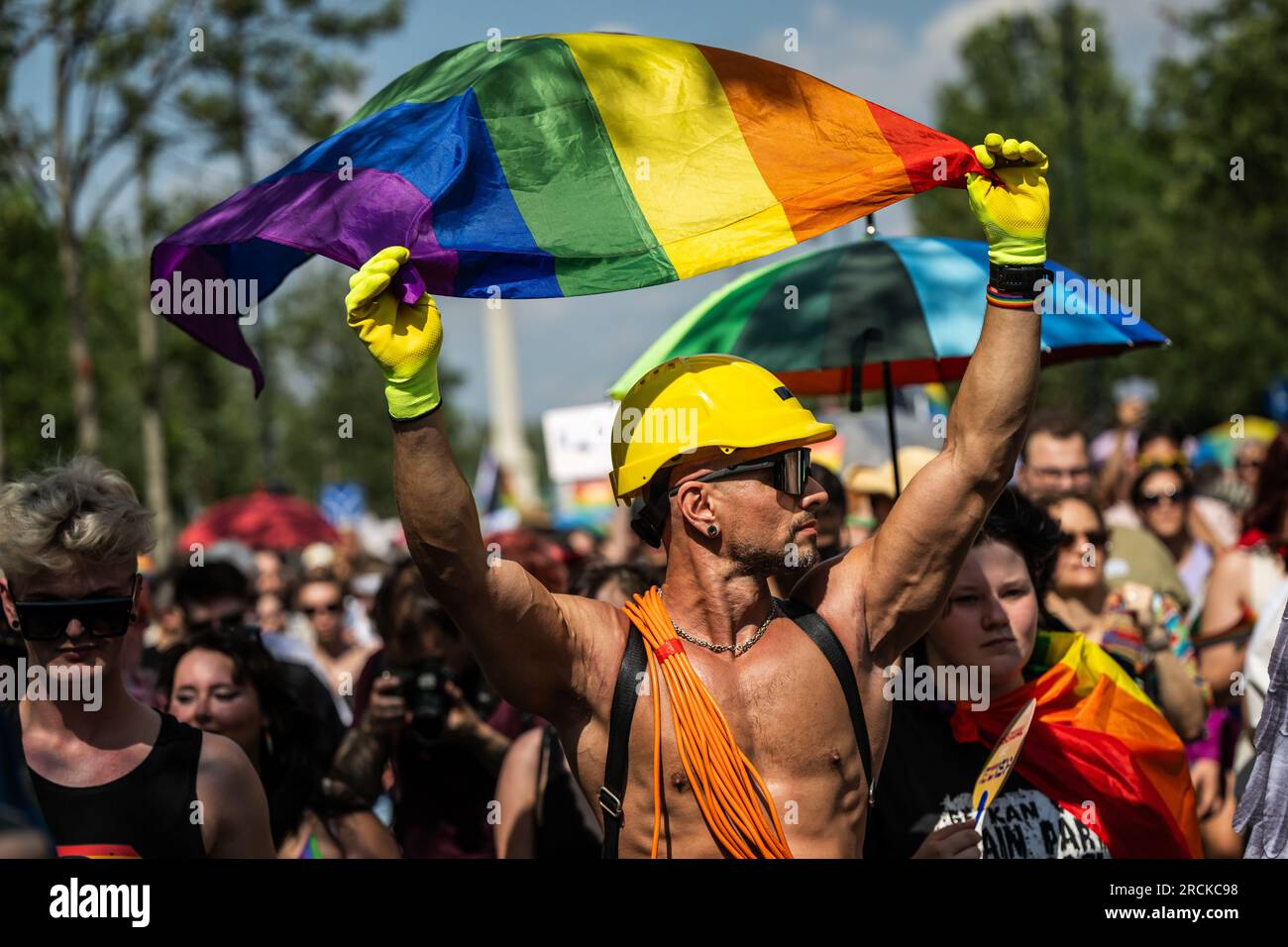 Budapest, Hungary. 15th July, 2023. A man with a rainbow flag takes part in the Pride parade in Budapest. For the past two years, Hungary has had a so-called 'child protection law' that falsely equates homosexuality with pedophilia. The law prohibits providing young people with information about homosexuality, transsexuality or gender reassignment. Credit: Marton Monus/dpa/Alamy Live News Stock Photo