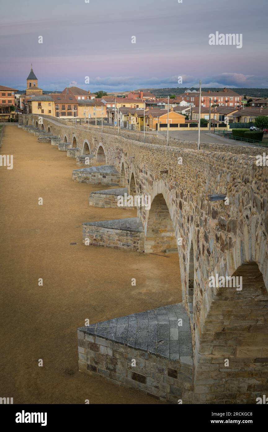 Summer's Awakening: Unveiling the Roman Bridge along the Camino de Santiago in Hospital de Orbigo, Leon, Spain Stock Photo