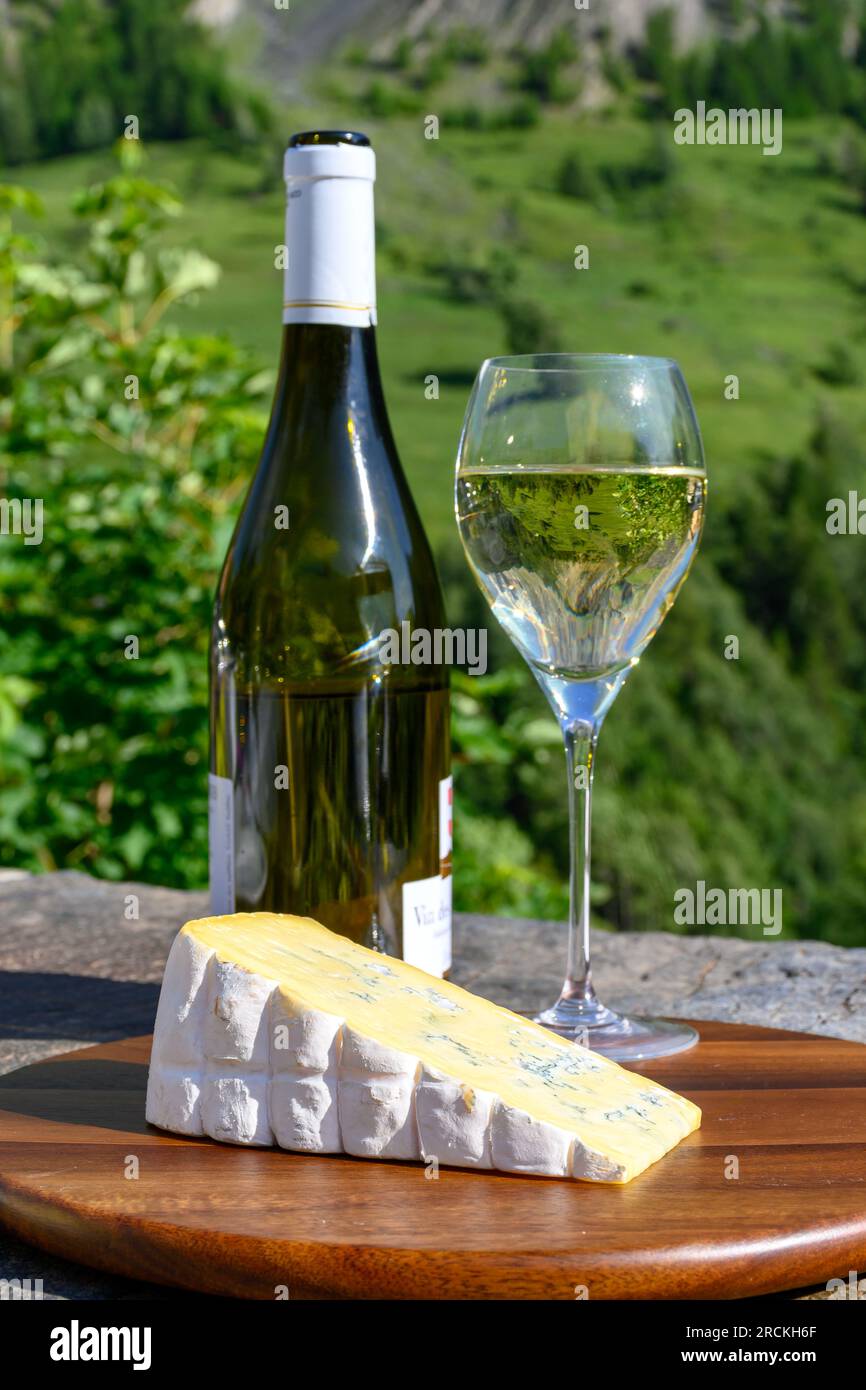 Cheese and wine, glasses of dry white Roussette de Savoie and Vin de Savoie wine from Savoy