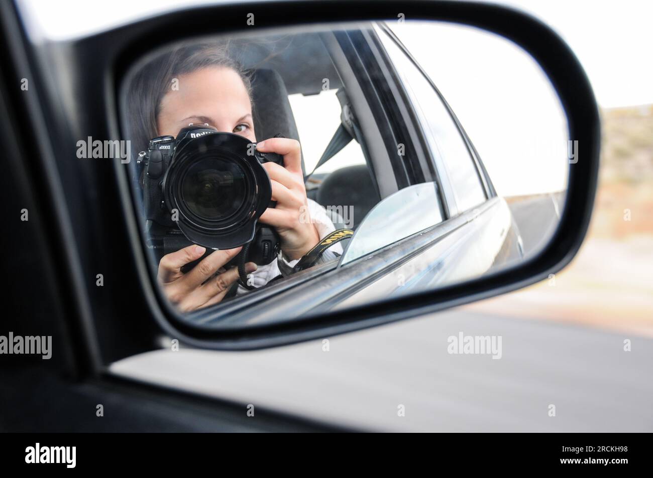 Self-portrait of girl in car mirror on a road trip through the American midwest Stock Photo