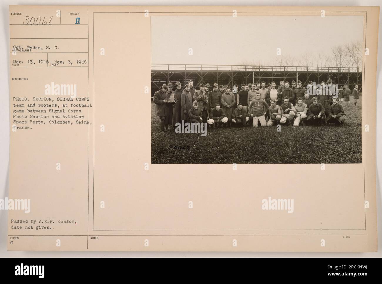 Sergeant Pyden and the rest of the team and spectators are seen here at a football game between the Signal Corps Photo Section and Aviation Spare Parts. The game took place in Colombes, Seine, France on December 13, 1918. The photograph was approved by the A.E.F. censor, although the specific date of censorship is unknown. Stock Photo