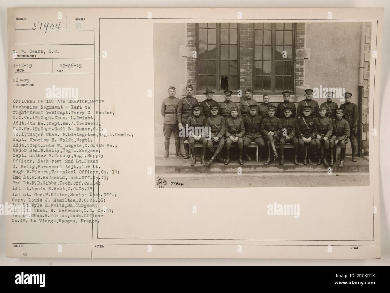 Caption: Officers of the 1st Air Service, Motor Mechanics Regiment, pictured at La Vierge, Vosges, France. The image features a front row, left to right: Capt. Terry C. Fester, C.C. Co.15; Capt. Chas. L. Dwight, Adjt. 4th B.; Capt. W.A. Tredwell, C.O. Co.19; Capt.Gail B. Hamer, C.C. Co.17; Major Chas. E. Livingston, Regtl. Comdr.; Capt. Charles E. Wolfe, Regtl. Adjt.; Capt. John W. Legate, C.O. 4th Bn.; Major Ben. W. Kelly, Regtl. Surgeon; Capt. Luther V. Godaey, Regt. Supply Officer. Back row: 2nd Lt. Frand D. Kelly, Personnel Adjt.; 1st Lt. Hugh W. Rivers, Technical Officer, Co. 17; 2nd Lt. Stock Photo