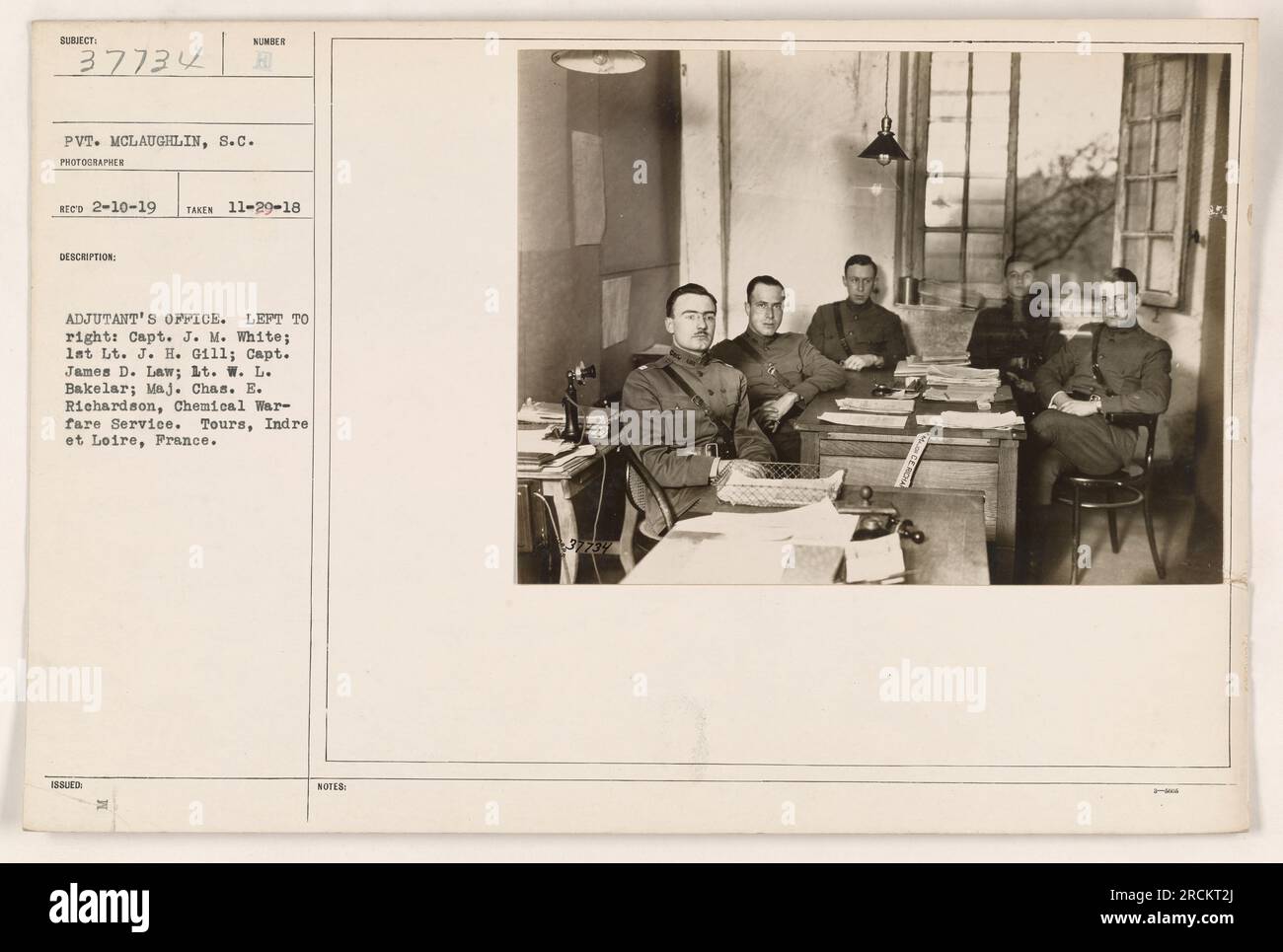 Pictured in this photograph is the Adjutant's Office in Tours, France during World War One. From left to right, the individuals are identified as Capt. J. M. White, lat Lt. J. H. Gill, Capt. James D. Law, 1t. W. L. Bakelar, and Maj. Chas. E. Richardson of the Chemical Warfare Service. This photograph was taken on November 29, 1918. Stock Photo