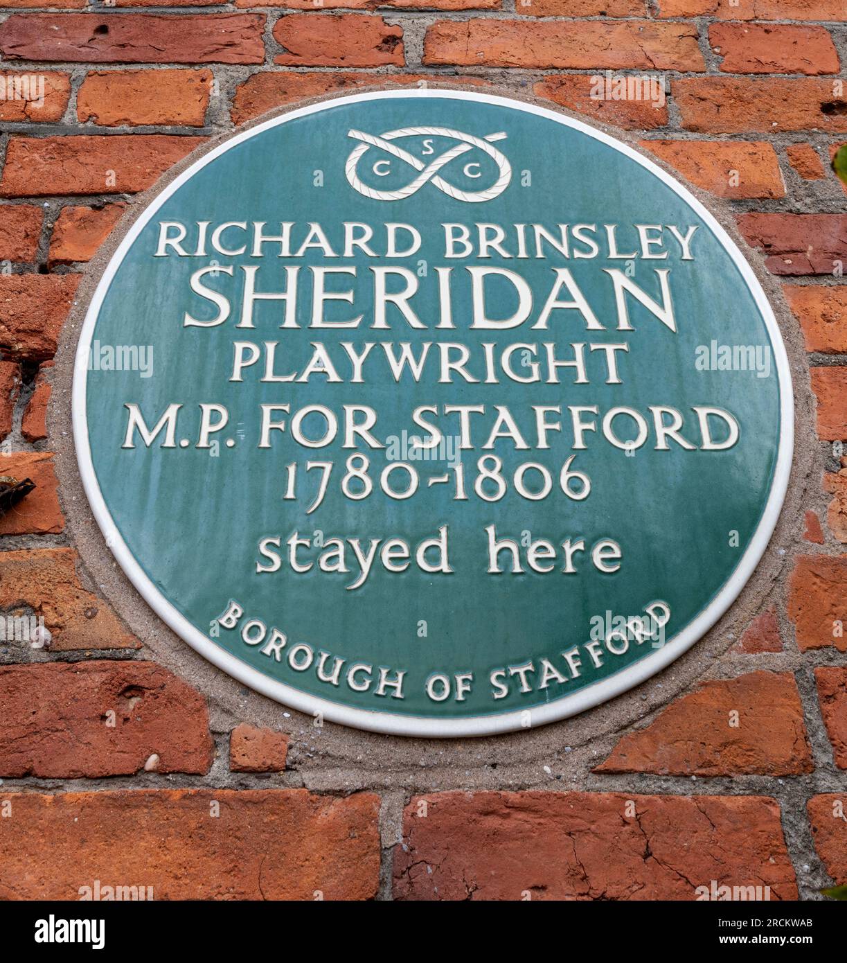 Green heritage plaque at The Post House, Stafford, Staffordshire, commemorating that Richard Brinsley Sheridan MP for Stafford stayed there. Stock Photo