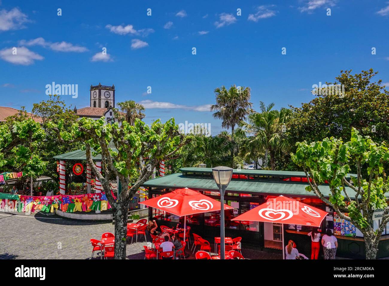 Festive pennants decorate the outdoor cafe at the Jardim Antero de Quental in the historic village of Vila Franca do Campo in Sao Miguel Island, Azores, Portugal. The village was established in the middle of the 15th century by Gonçalo Vaz Botelho. Stock Photo