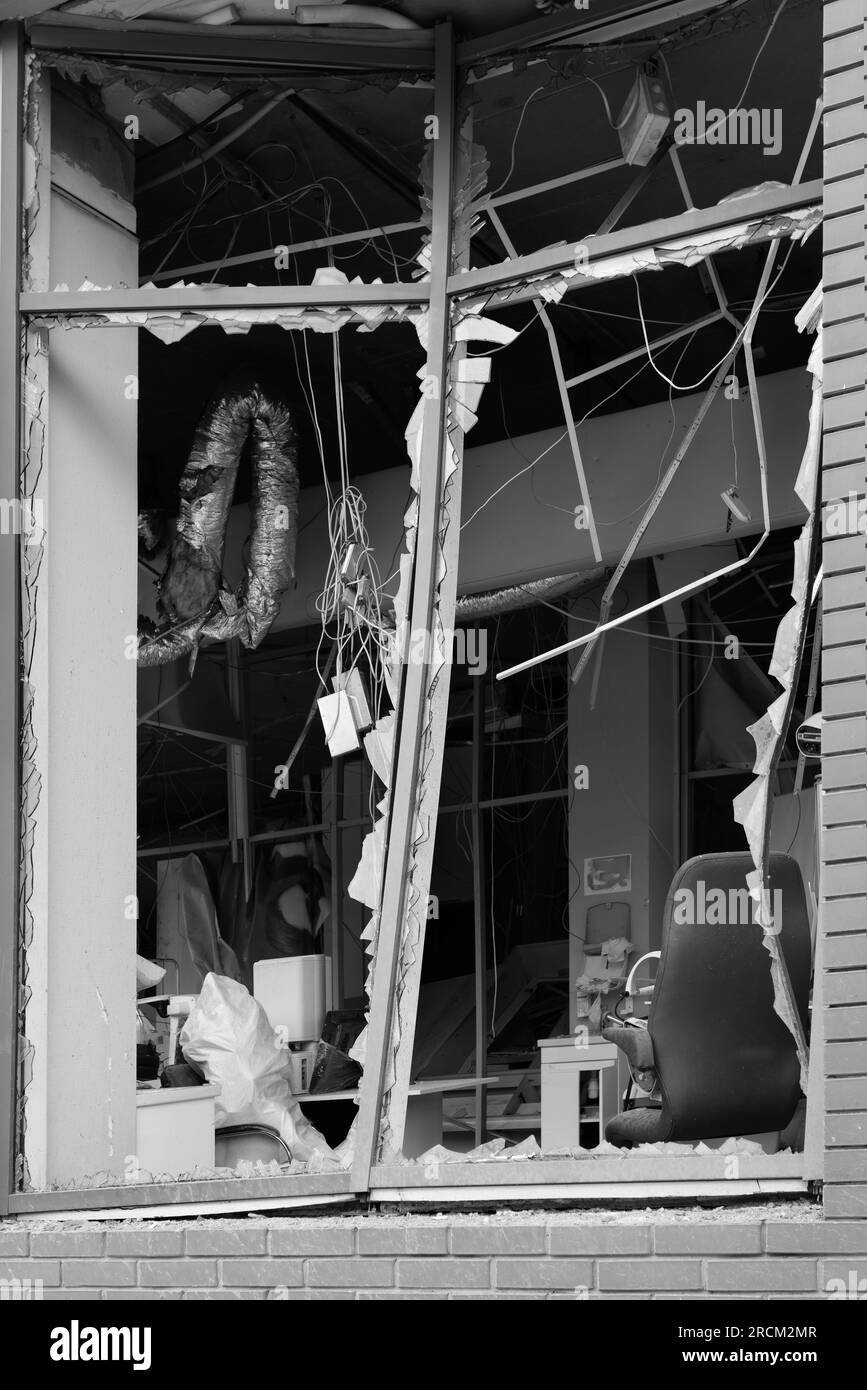 Broken windows of civilian building of bomb explosion. Shards of glass
