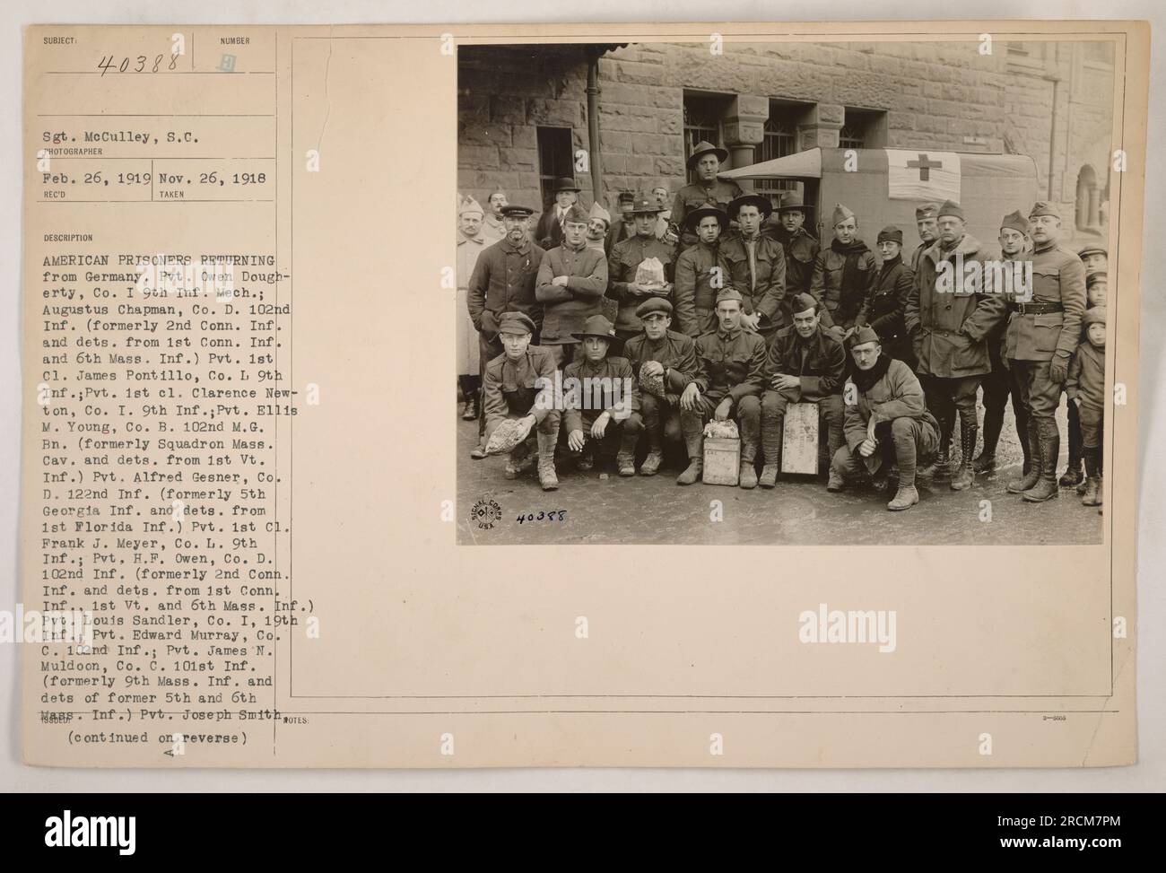 American prisoners returning from Germany. The individuals in the photograph include Sgt. McCulley and several privates from various infantry and cavalry units. Some of them previously served in different state infantry units. Names listed are Pvt. Owen Dougherty, Augustus Chapman, Pvt. 1st cl. James Pontillo, Pvt. 1st cl. Clarence Newton, Pvt. Ellis M. Young, Pvt. Alfred Gesner, Pvt. 1st cl. Frank J. Meyer, Pvt. H.F. Owen, Pvt. Louis Sandler, Pvt. Edward Murray, and Pvt. James M. Muldoon. (continued on reverse) Stock Photo