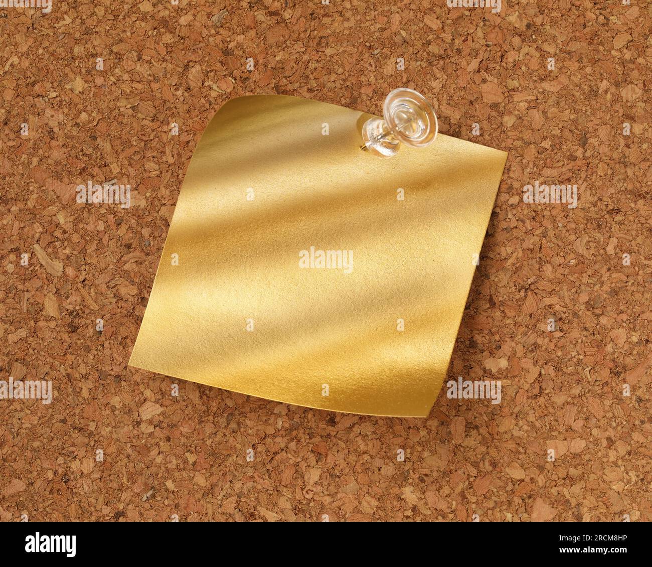 Shiny blank gold sticky note pinned with tack. Golden idea or message concept. Stock Photo