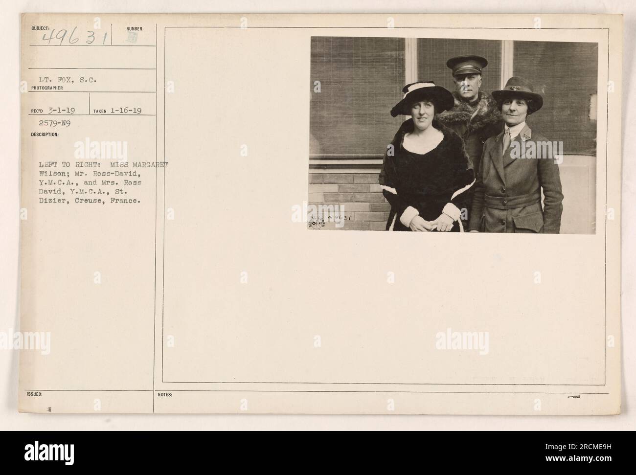 Left to right: Miss Margaret Wilson; Mr. Ross-David, Y.M.C.A.; and Mrs. Ross-David, Y.M.C.A. at St. Dizier, Creuse, France. This photo was taken on January 16, 1919, and received on March 1, 1919. Lieutenant Fox, S.C., was the photographer. The photo's description number is 2579-N9. Stock Photo
