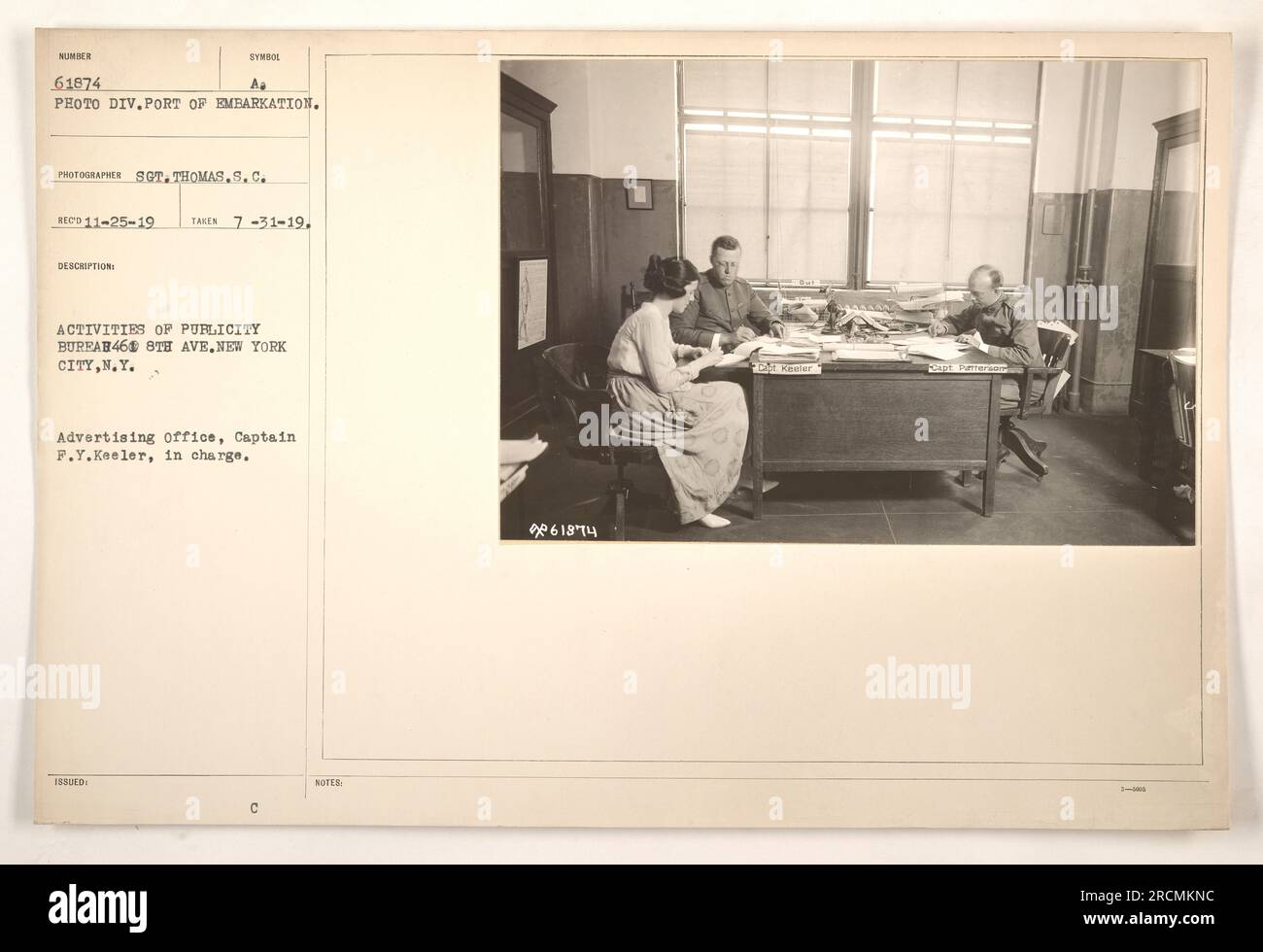 Captain F.Y. Keeler, the assistant advertising officer in charge of the Publicity Bureau in New York City, is seen in this photograph. The image depicts the activities of the bureau, which was responsible for advertising and promotional efforts during World War One. The photographer, Sgt. Thomas S.C. Peterson, took the photo on July 31, 1919. The image is part of the collection from the Port of Embarkation and is labeled with the identification number 61874. Stock Photo