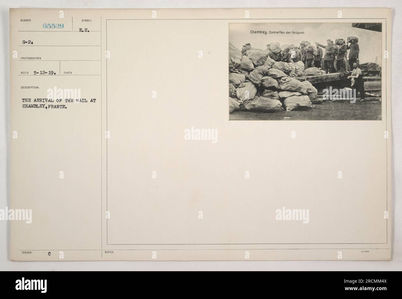 Soldiers eagerly gather to receive their mail at Chambley, France during World War I. The arrival of the mail is an important morale booster for the troops and provides a connection to loved ones back home. Stock Photo