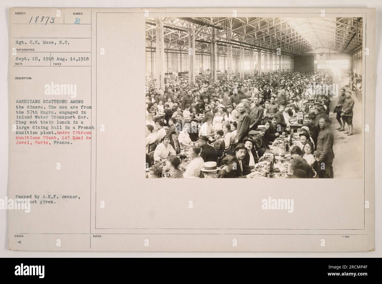 Soldiers from the 57th Engineers, serving in the Inland Water Transport Service, are seen having lunch in a dining hall located in the Andre Citroen Munitions Plant in Paris, France. The photograph was taken on August 14, 1918, by Sergeant C.E. Mace, and was approved by the A.E.F. censor for release. Stock Photo