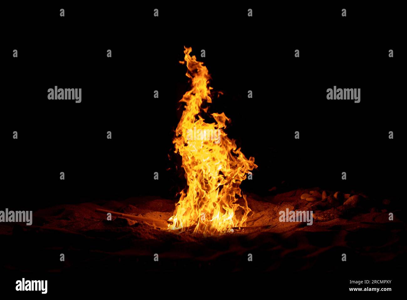 Fire flame burning isolated on dark background. Abstract fireplace burning light on black backdrop. Stock Photo