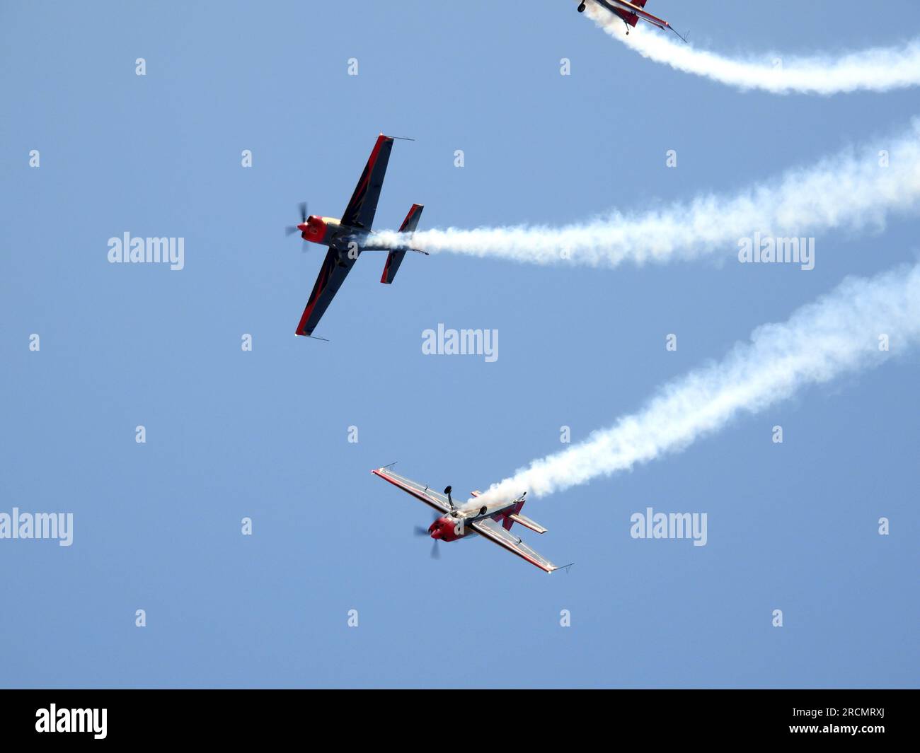 Smoke billows from three planes performing an airshow in the sky (Royal