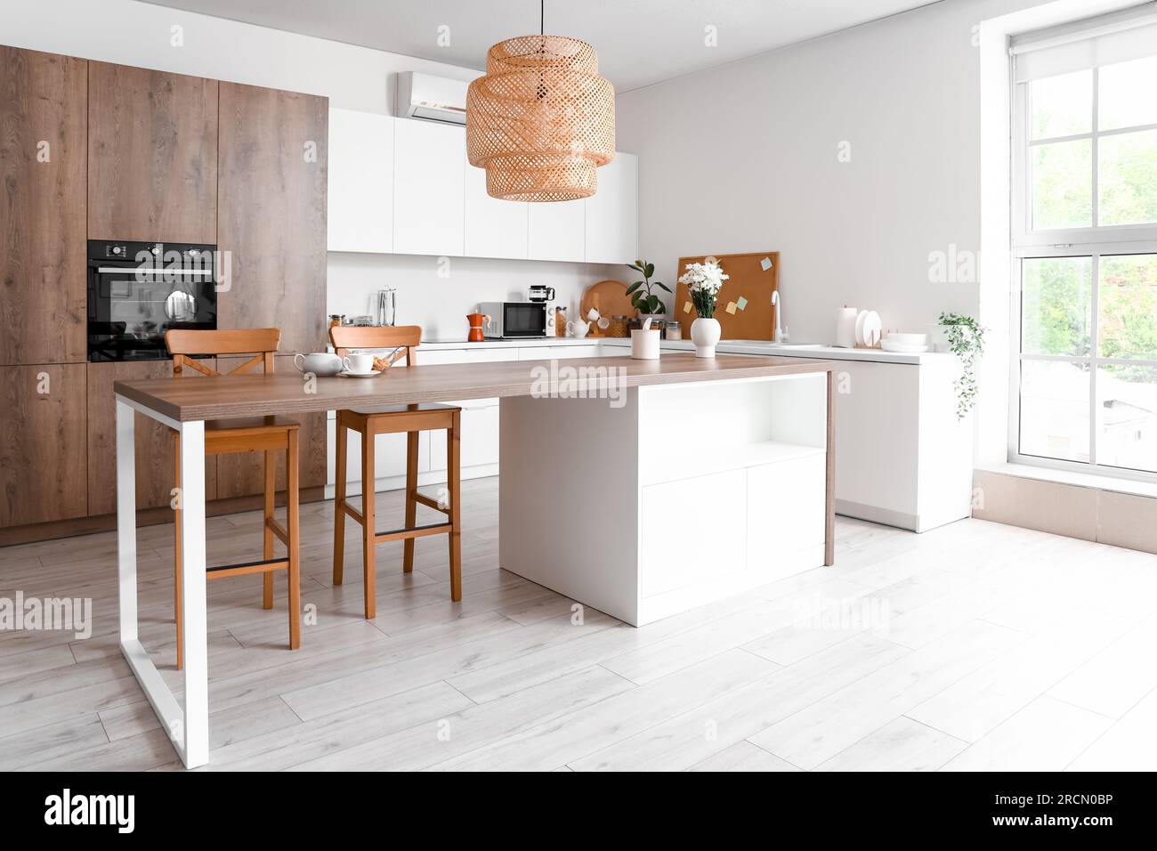 Interior of light kitchen with dining table and counters Stock Photo ...