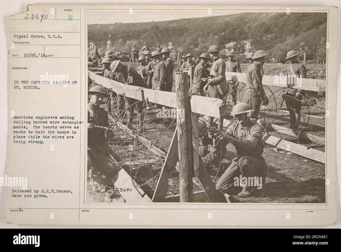 American engineers constructing rolling barbed wire entanglements in the captured salient of St. Mihiel during World War One. The racks made from boards are used to hold the hoops in place while the wires are being strung. The photograph was released by A.E.F. Censor and the date is not provided. Stock Photo