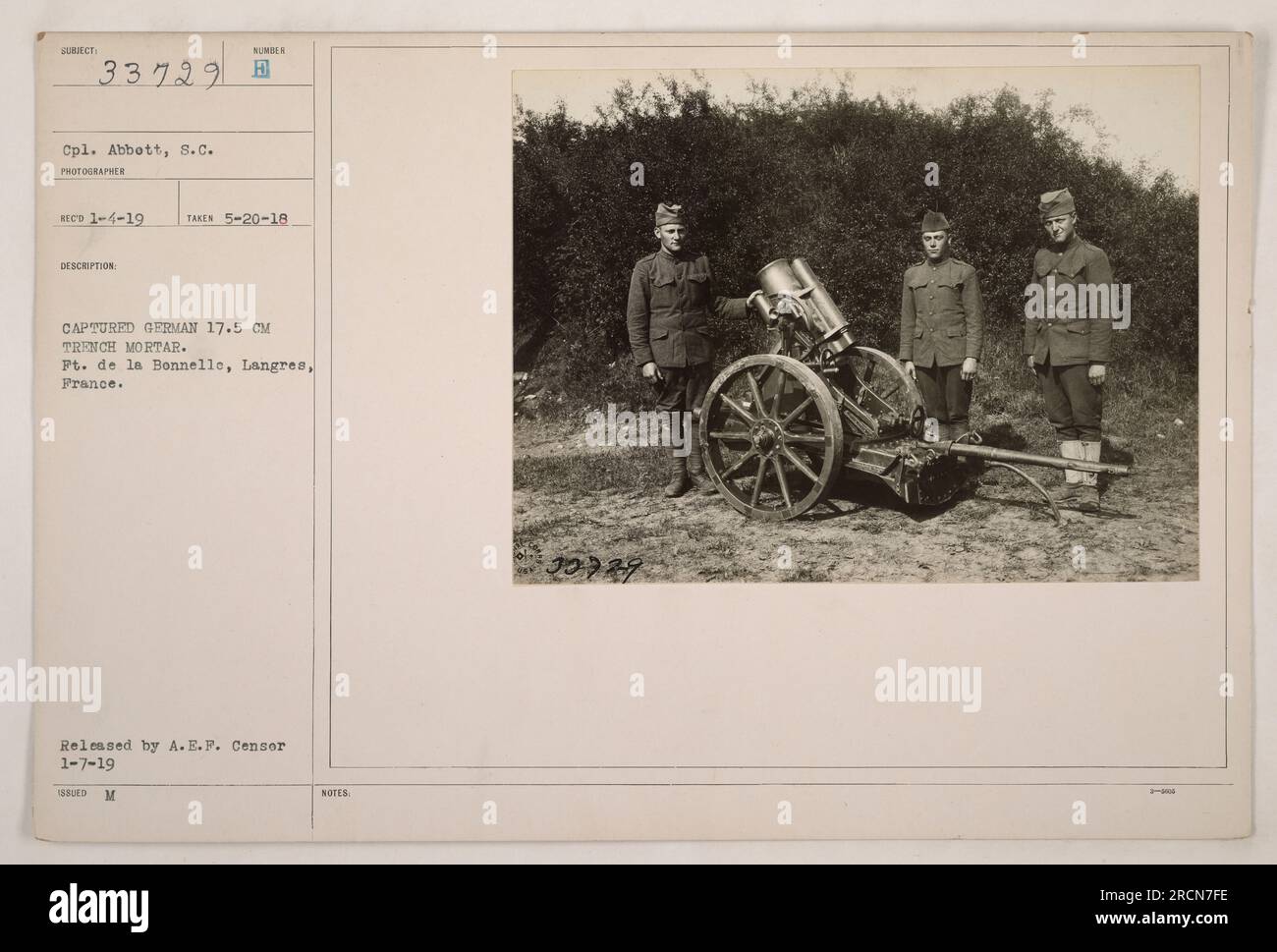 Cpl. Abbott of the American military is pictured with a captured German 17.5 cm trench mortar at Ft. de la Bonnelle, Langres, France. The photograph was taken on May 20, 1918 and released by the A.E.P. on January 7, 1919. Photo reference number is 111-SC-33729. Stock Photo