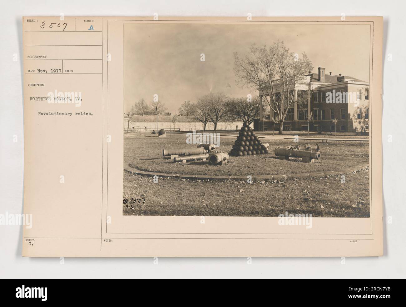 A photograph taken in 1917 at Fortress Monroe, Virginia, showcasing Revolutionary relics. This image is part of the collection labeled 111-SC-3507, captured by the photographer RECO Now. The description of the photo highlights the historical significance of Fortress Monroe and its connection to the American Revolution. Stock Photo