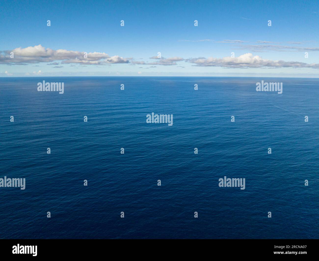 Flying from above of Deep Blue Sea. Skyline over the sea. Surigao del Sur. Mindanao, Philippines. Stock Photo