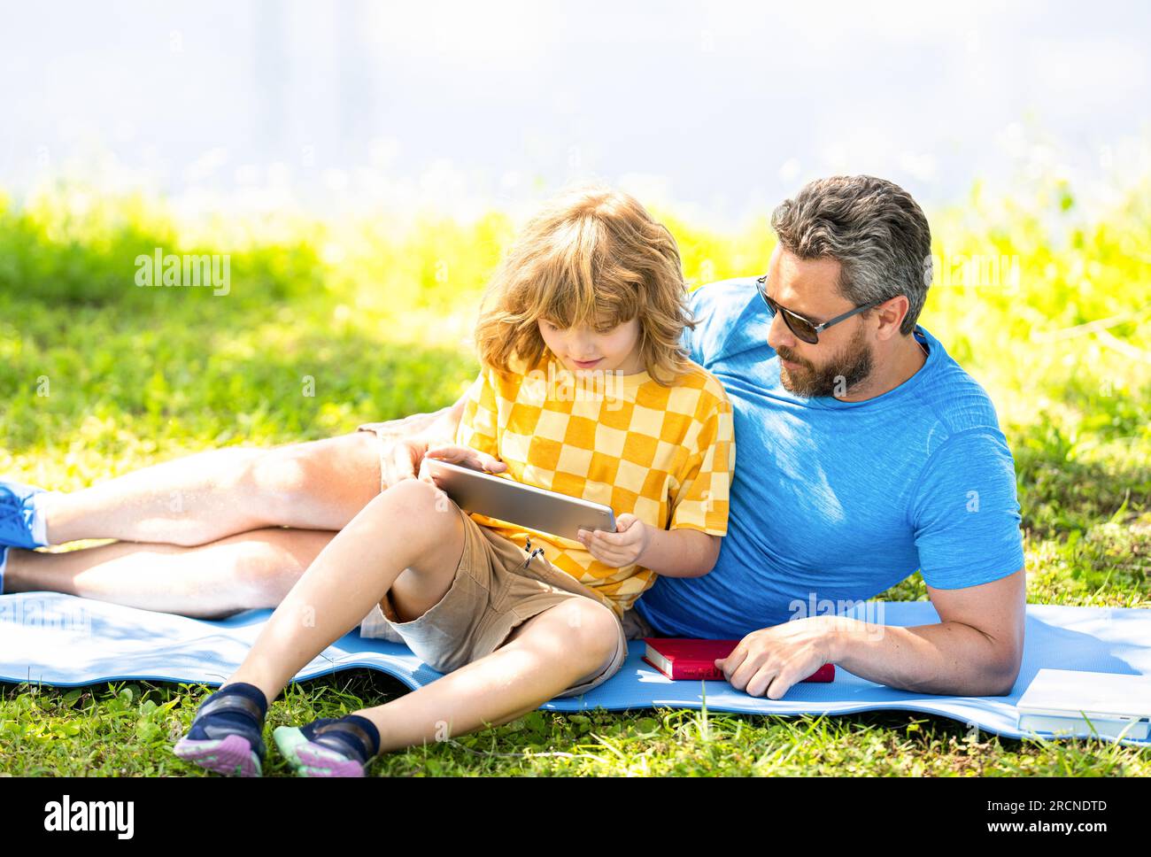 Father and son relax in park. childhood school education. son with father bonding in summer. family education of father and son kid. Father shapes son Stock Photo
