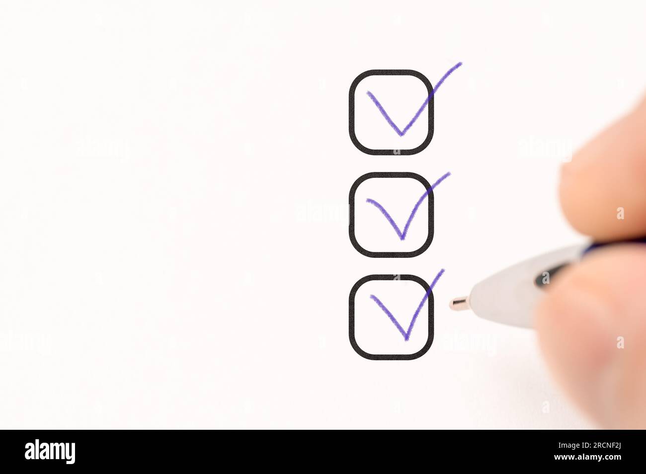 three checkboxes. marking on checklist box. hand with pen writing check