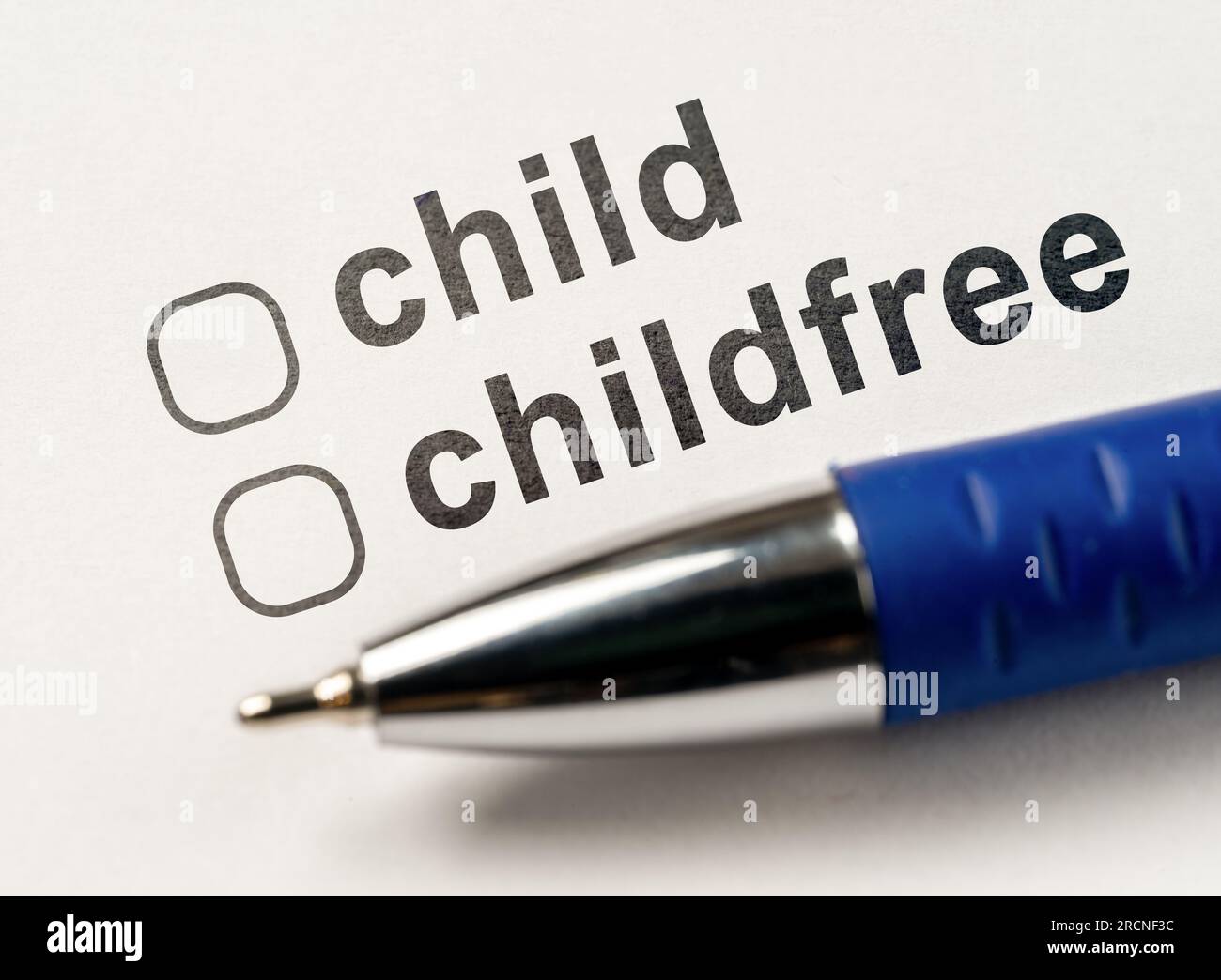 Child or Childfree checkbox on white paper with blue pen. Two checklists to choose between child and without children. decide whether to stay childfre Stock Photo