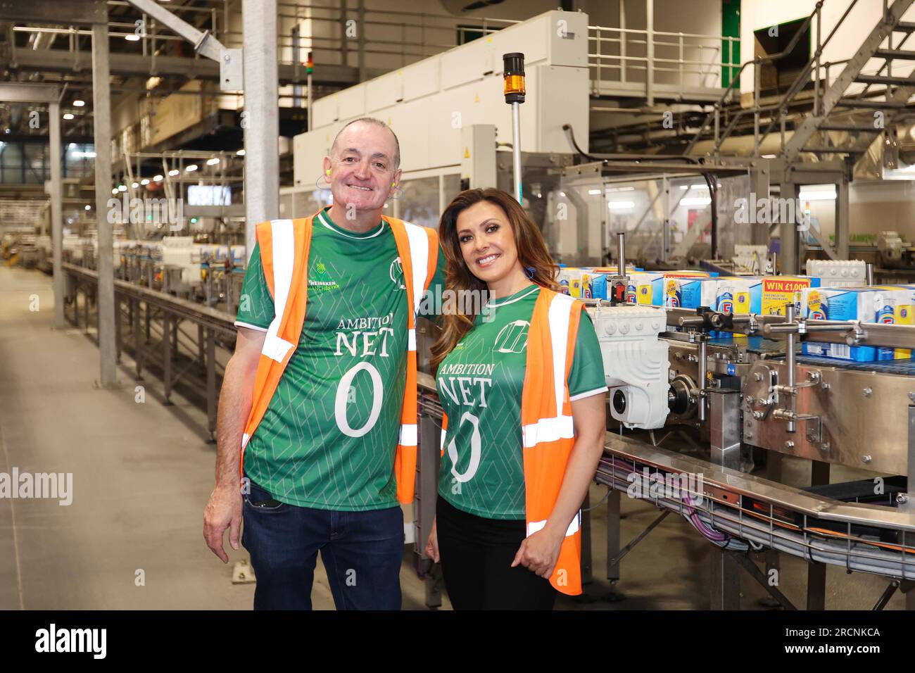EDITORIAL USE ONLY Manchester United fan, Kym Marsh and Manchester City fan, Craig Cash put their differences aside and don green shirts during a tour of HEINEKEN UK's flagship Manchester brewery to celebrate a £25m investment into the brewery in support of the company's global net zero 2030 ambitions. Issue date: Sunday July 16, 2023. Stock Photo