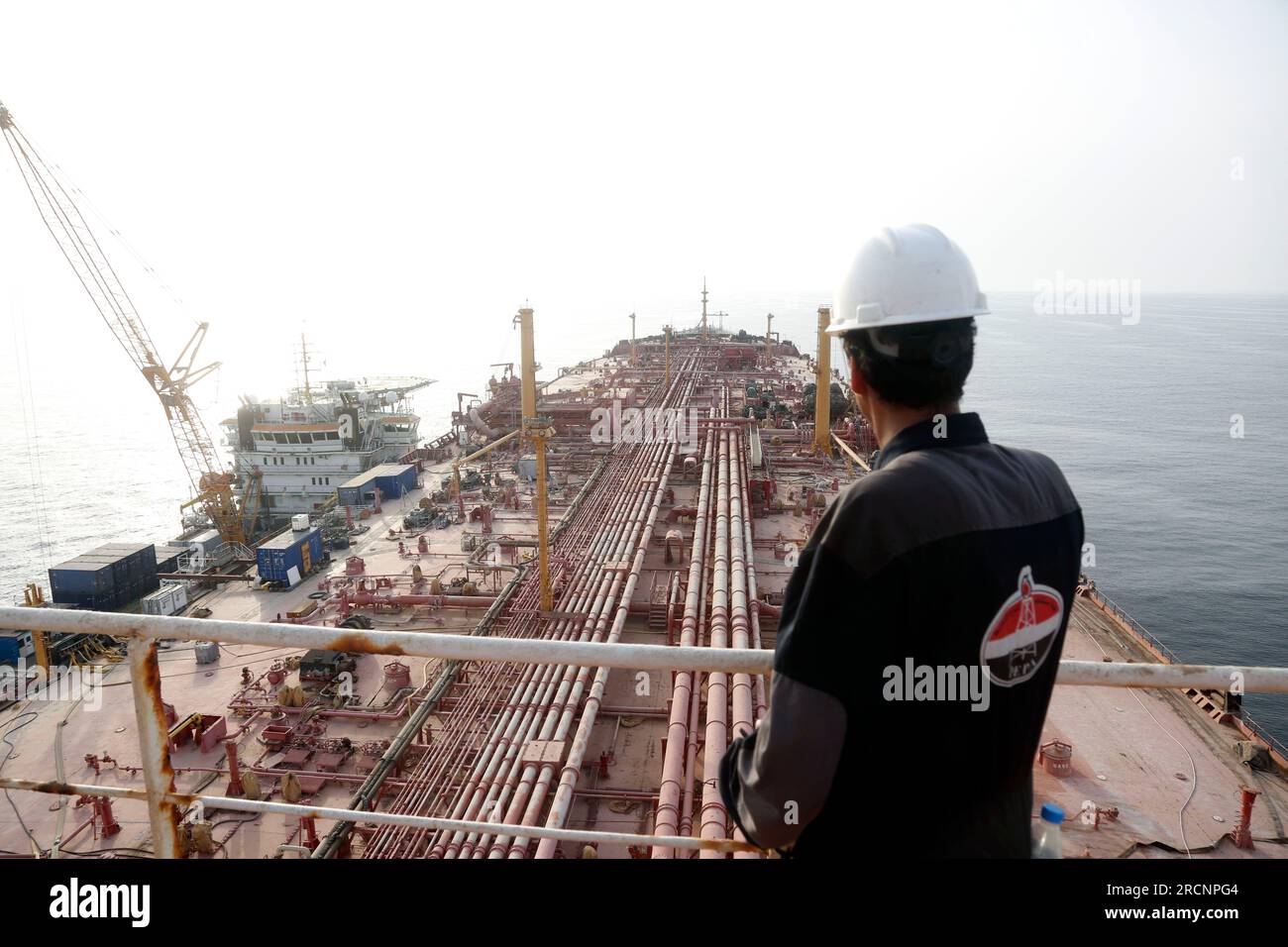 (230716) -- HODEIDAH, July 16, 2023 (Xinhua) -- A engineer stands on the upper decker of the FSO Safer, a super oil tanker that has been left unattended for years, at Ras Issa Port in Hodeidah Province, Yemen, on July 15, 2023. A vessel chartered by the United Nations set sail from Djibouti on Saturday toward Yemen to transfer oil from a deteriorating tanker that poses a major environmental and humanitarian threat. The replacement vessel, Nautica, is expected to arrive at the site of the FSO Safer supertanker on Sunday. Once it arrives, a meticulous ship-to-ship transfer operation will be init Stock Photo