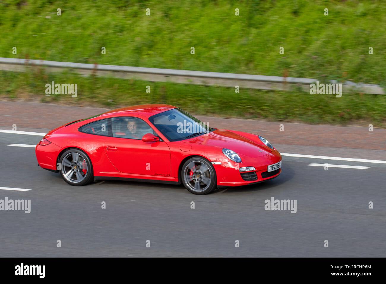 2010 Porsche 911 Carrera 4S Pdk S-A PDK Auto Car Coupe Petrol 3800 cc; travelling at speed on the M6 motorway in Greater Manchester, UK Stock Photo