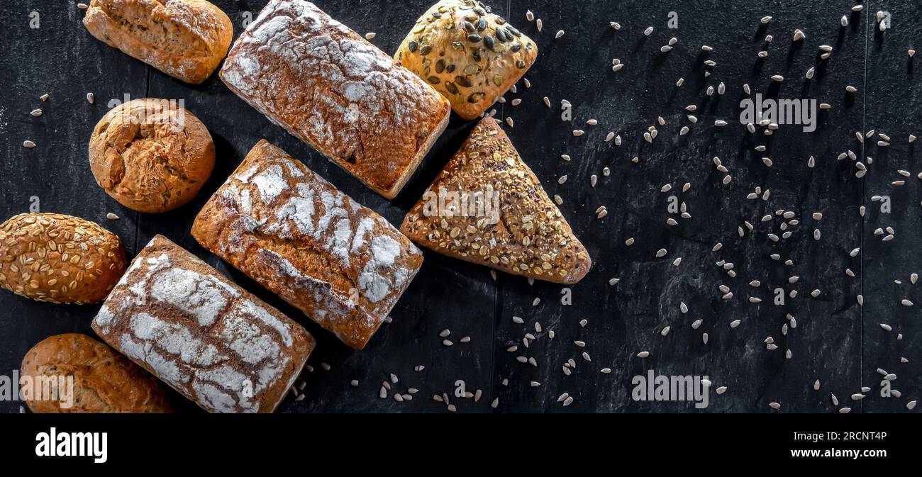 Assorted bakery products including loaves of bread and rolls Stock Photo