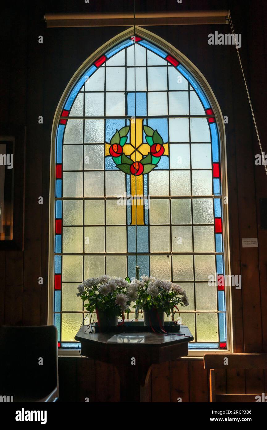 A stained glass window in the corrugated iron church of St. Mary's at Newton-by-the-Sea in Northumberland, UK Stock Photo