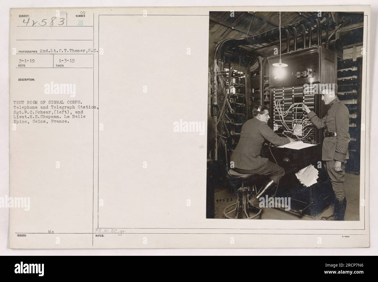 This photograph, taken on March 1, 1919, by 2nd Lt. C.T. Thoner, shows a test room of the Signal Corps Telephone and Telegraph Station at Le Belle Epine, Seine, France. It features Sgt. W.C. Sehear on the left and Lt. H.H. Chapman. Stock Photo