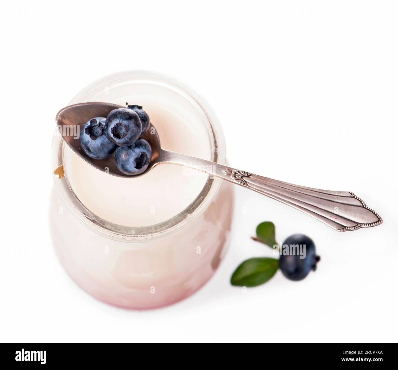 Yogurt in a jar with raw organic blueberries on white background Stock Photo