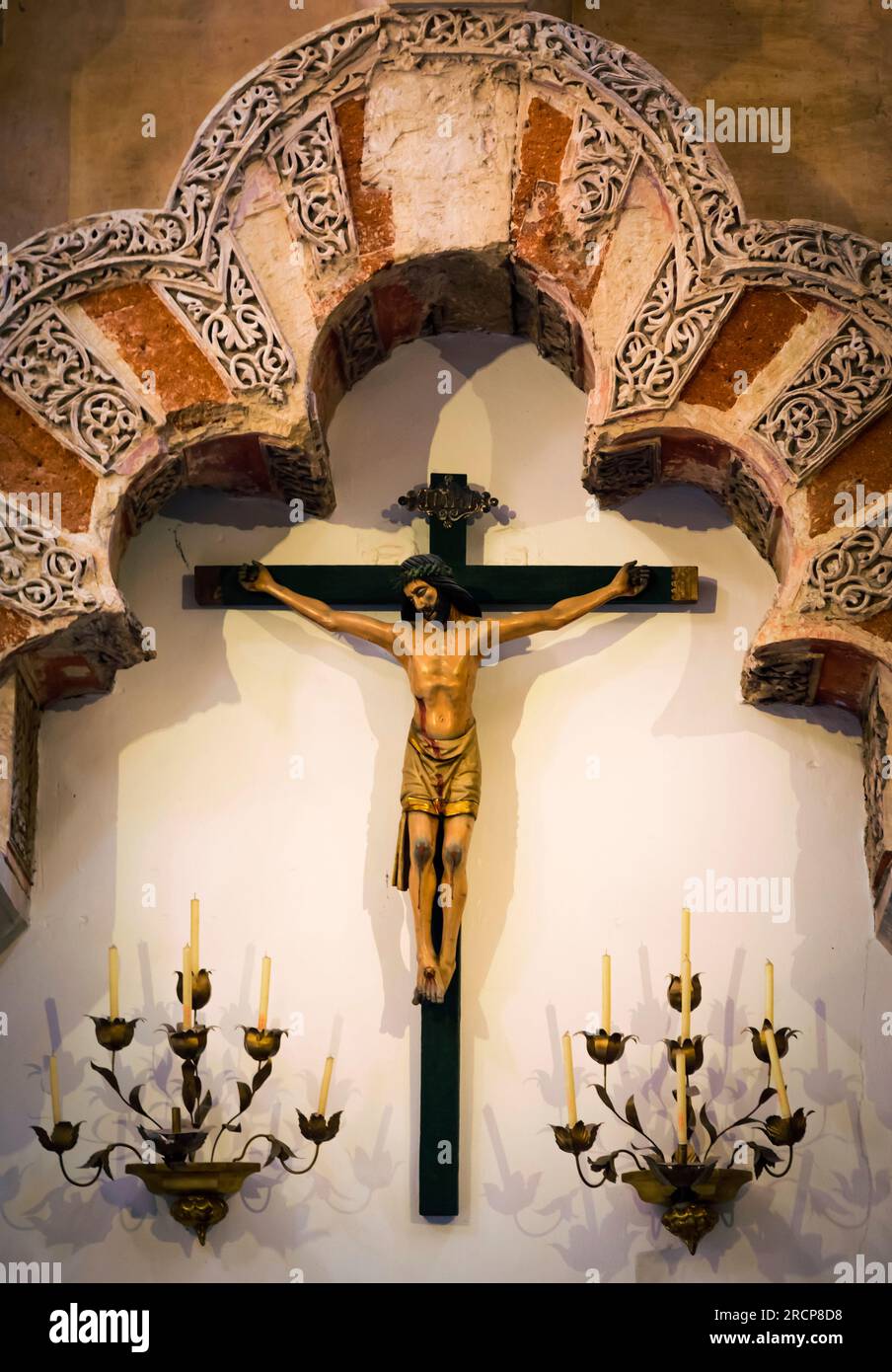 Cordoba, Cordoba Province, Andalusia, southern Spain.  Interior of the Great Mosque, La Mezquita.  A crucifix, symbol of Christianity, hangs beneath a Stock Photo