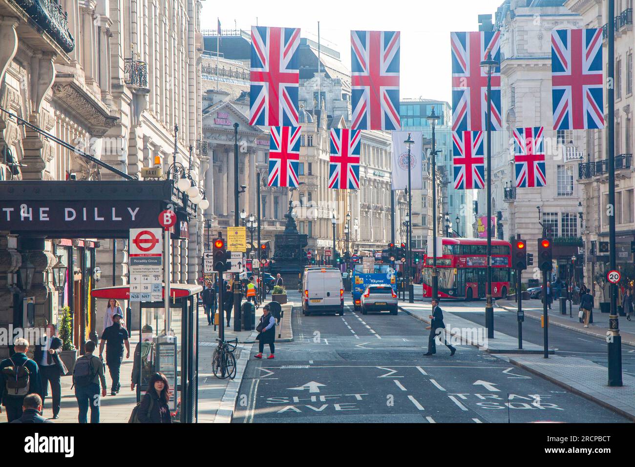 Union Jack flags on Piccadilly as people go to work Stock Photo
