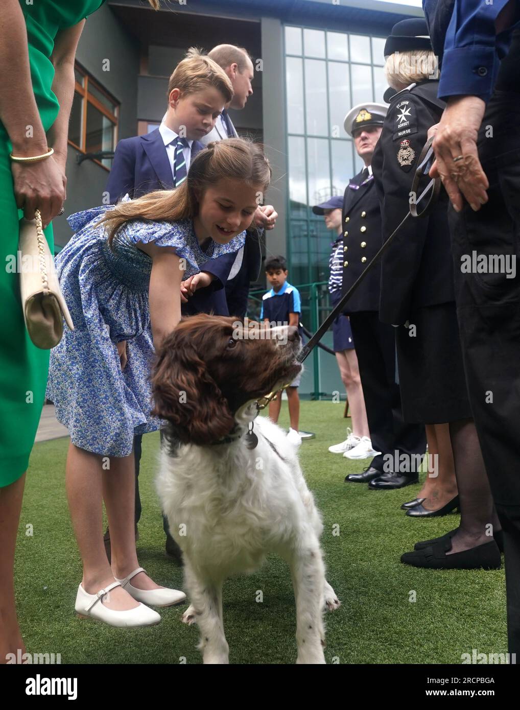 The Prince and Princess of Wales with Prince George and Princess Charlotte speak to Flt Sgt Jacquie Crook Royal Air Force, Pam West Tactical Commander St. John's Ambulance, Lt Cdr Chris Boucher Royal Navy and PC Erica Williams with springer spaniel Police Dog Stella on day fourteen of the 2023 Wimbledon Championships at the All England Lawn Tennis and Croquet Club in Wimbledon. Picture date: Sunday July 16, 2023. Stock Photo
