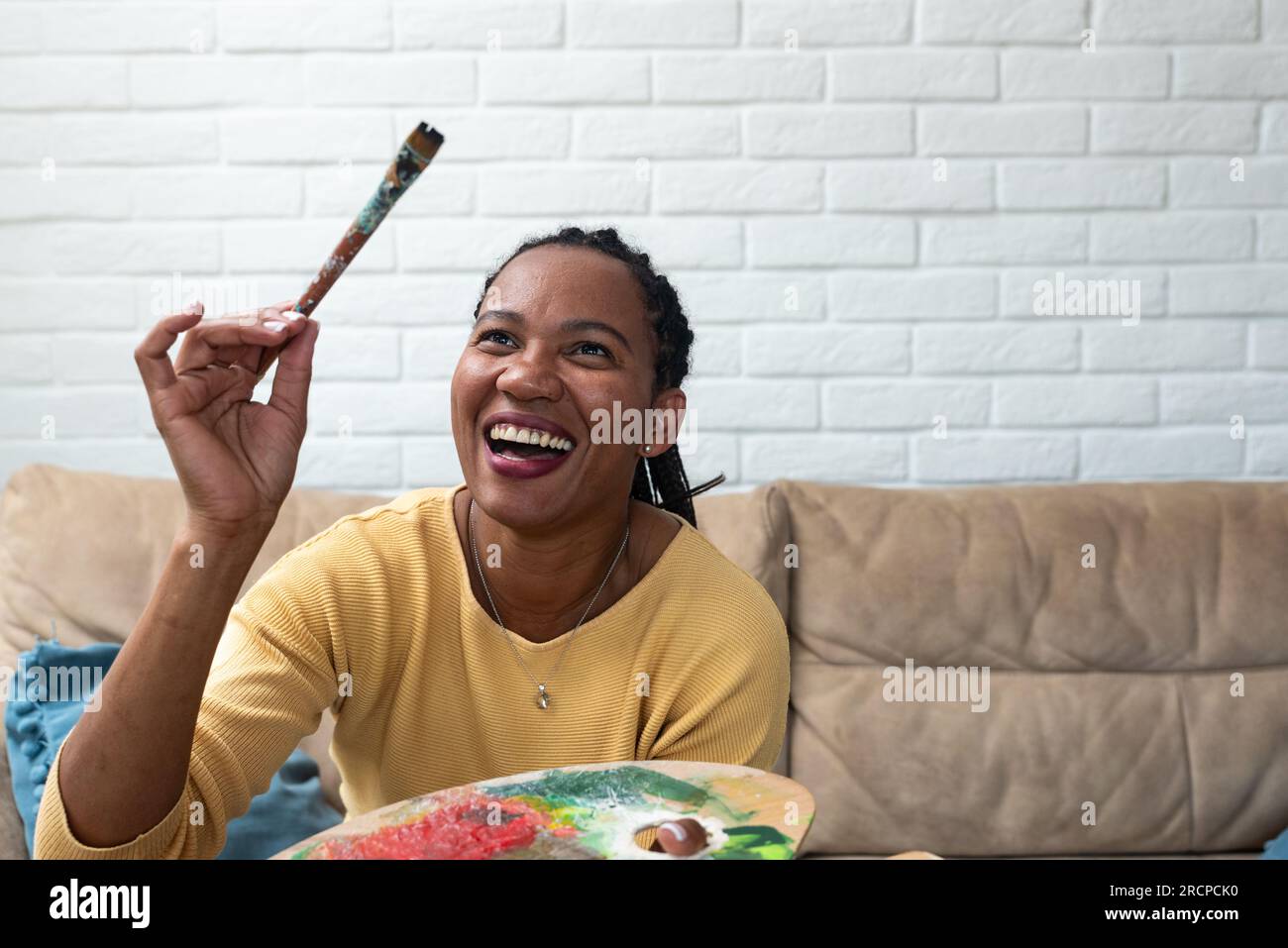 African American woman artist smiling confident drawing at art studio ...
