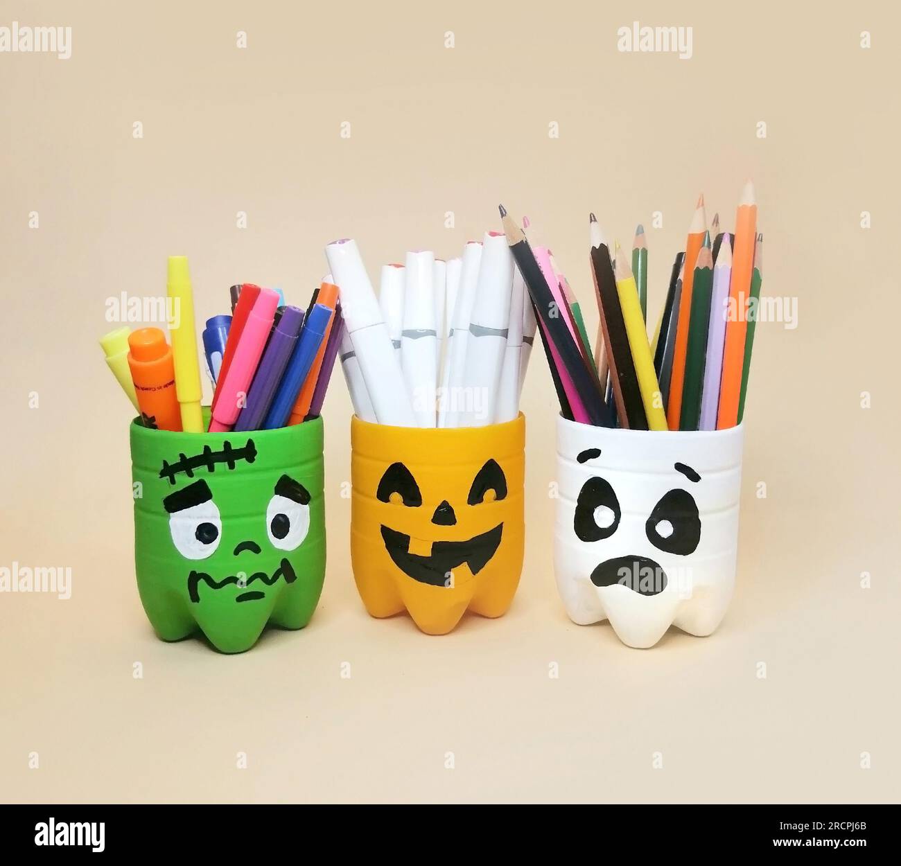 The art of handmade recycling from plastic bottle. Craft ideas of container for pencils. Crafts for the children's activity Stock Photo