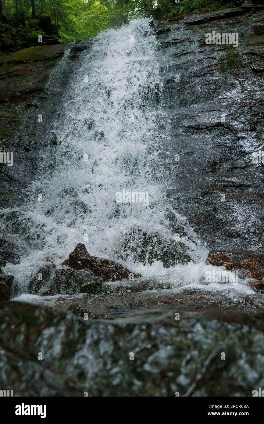 Waterfall cascade on mountain cliffs. Mountain waterfall in the mountains. Mountains Carpathians Stock Photo