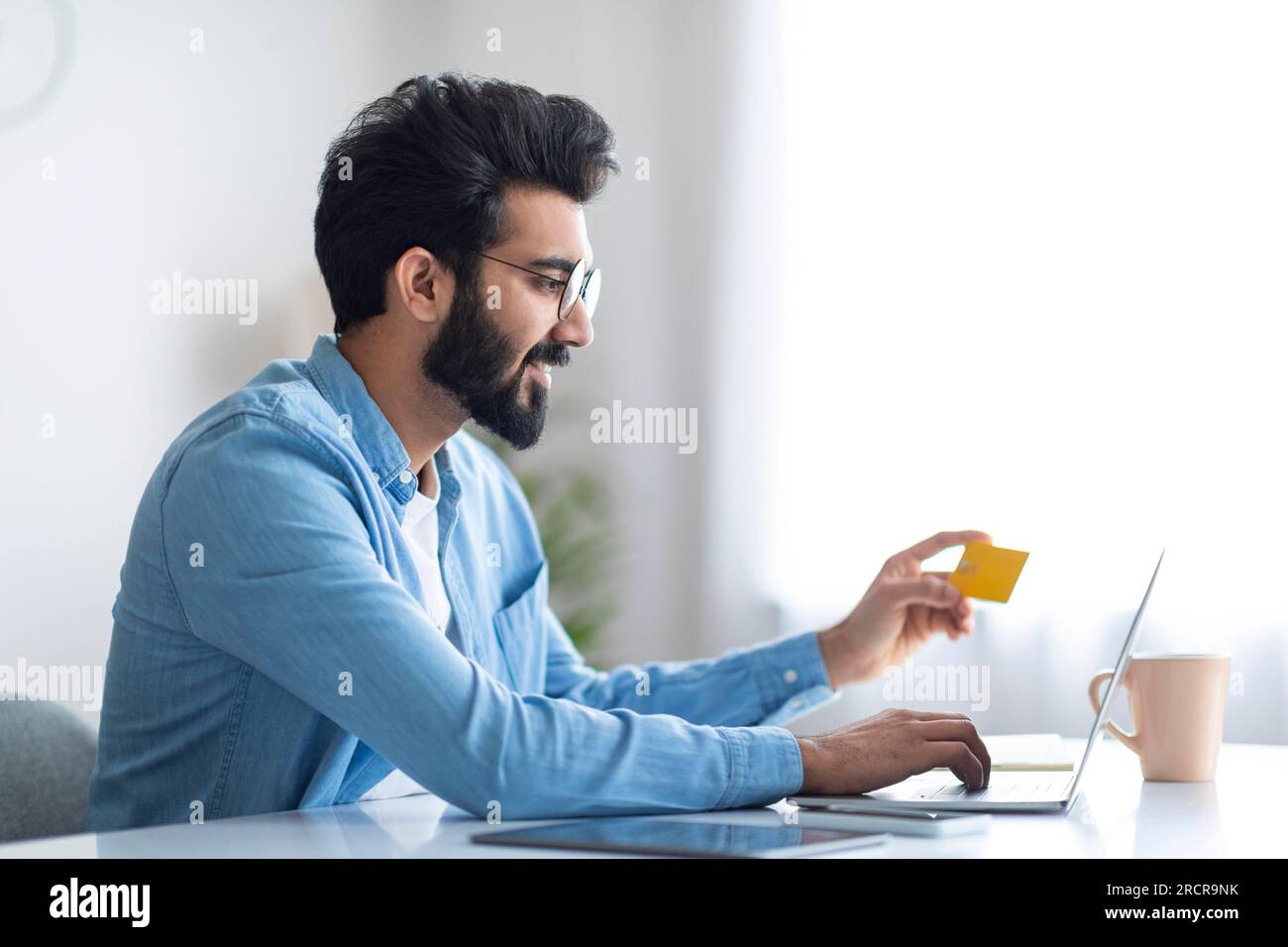 Online Shopping. Cheerful Indian Man Using Credit Card And Laptop ...
